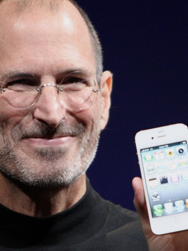 Steve Jobs holding an iphone